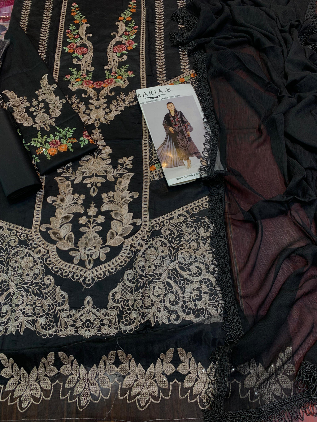 Shop the Maria B embroidered lawn suit with cutwork border and chiffon dupatta. Order now from IZ Pattern and Place.
