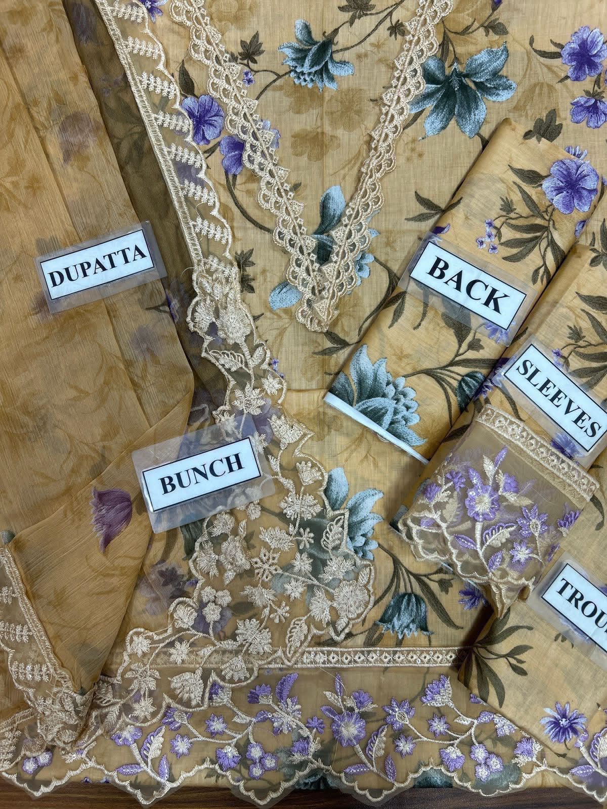 Shop the Cross Stitch digital printed lawn 3-piece unstitched suit with chiffon dupatta, digital printed trouser, and embroidered organza detailing. Order now from IZ Pattern and Place.