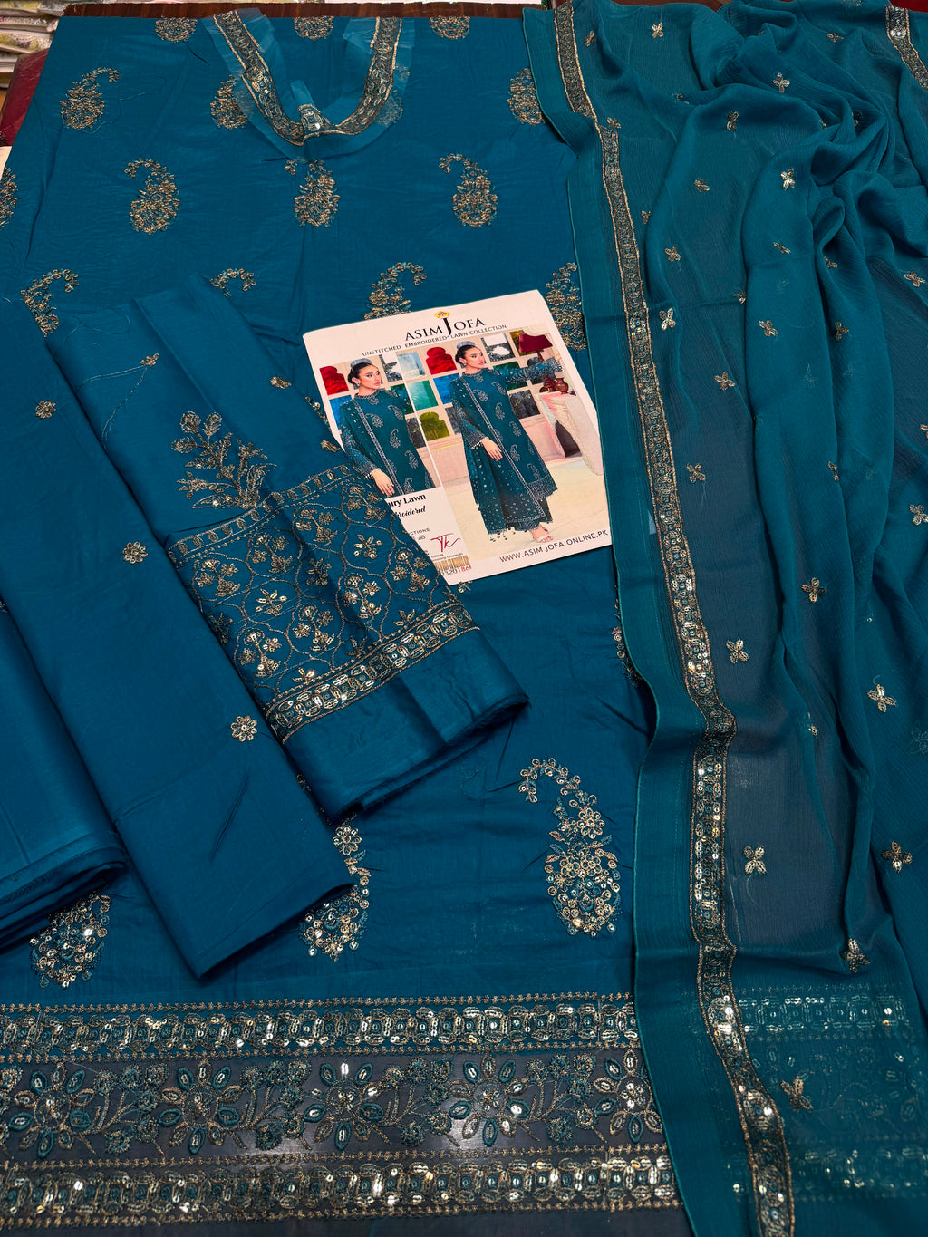 Shop the Asim Jofa luxury lawn 3-piece unstitched suit with embroidered front, sleeves, border, and embroidered chiffon dupatta. Order now from IZ Pattern and Place.