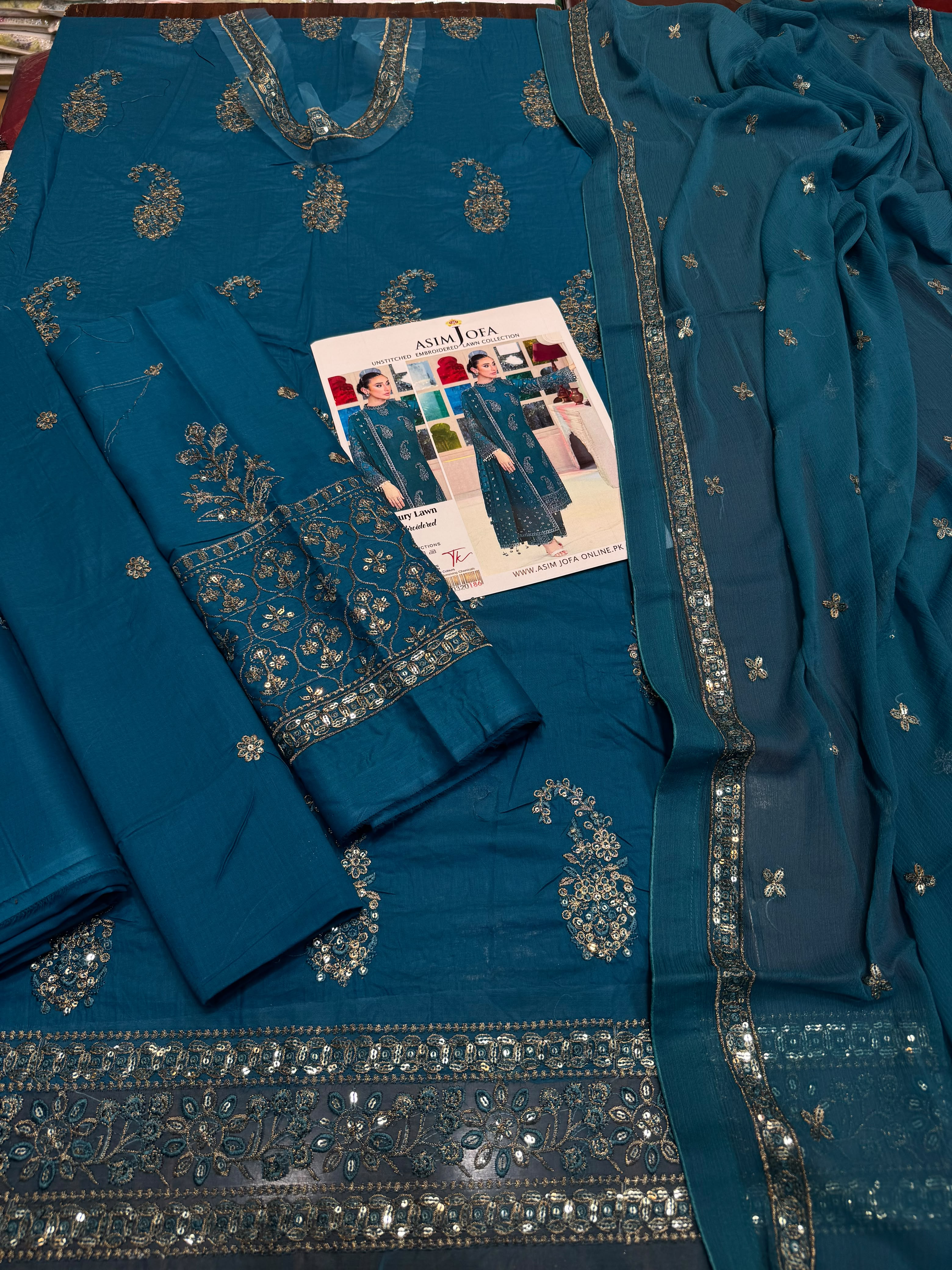 Shop the Asim Jofa luxury lawn 3-piece unstitched suit with embroidered front, sleeves, border, and embroidered chiffon dupatta. Order now from IZ Pattern and Place.