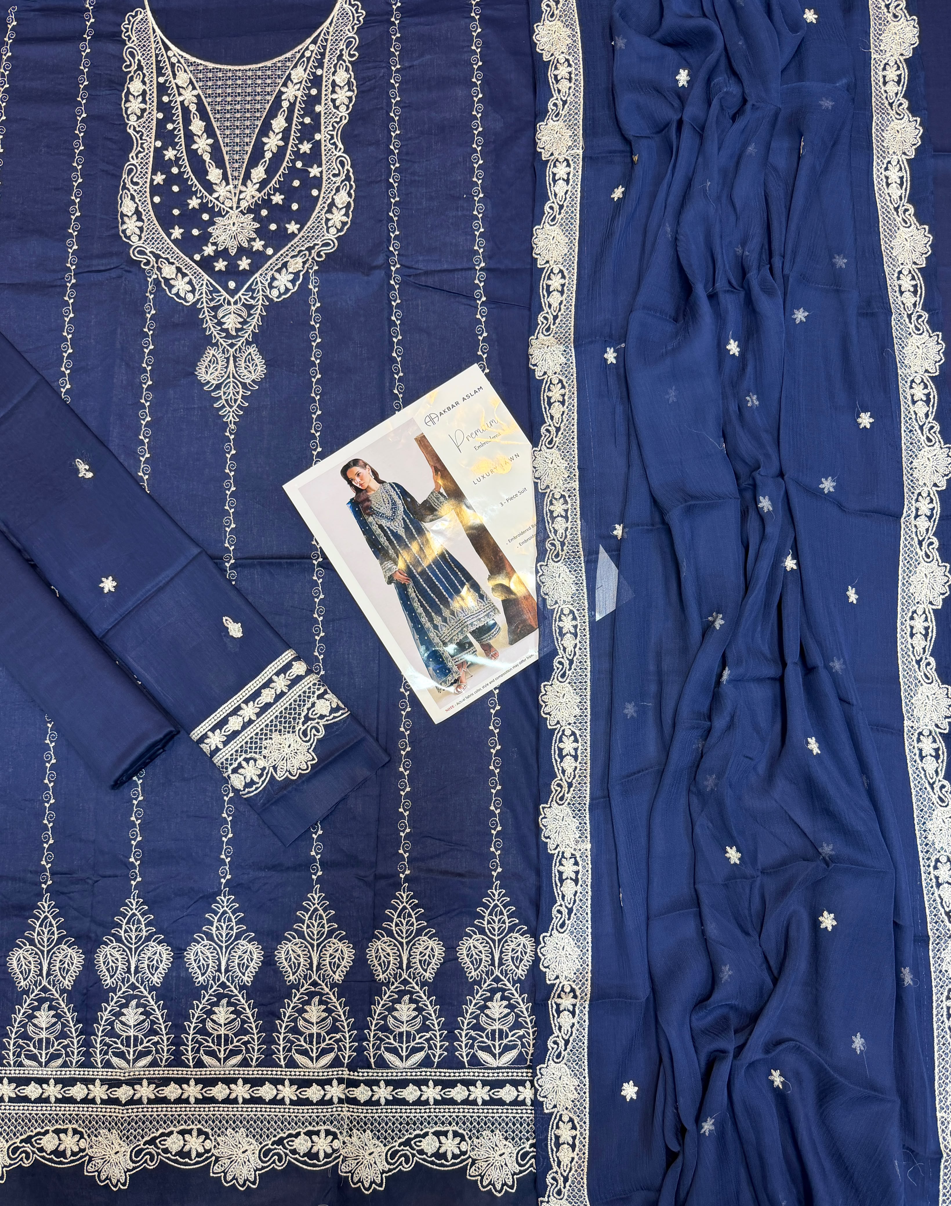 Shop the Akbar Aslam luxury lawn 3-piece unstitched suit with embroidered front, sleeves, border, and embroidered chiffon dupatta. Order now from IZ Pattern and Place.