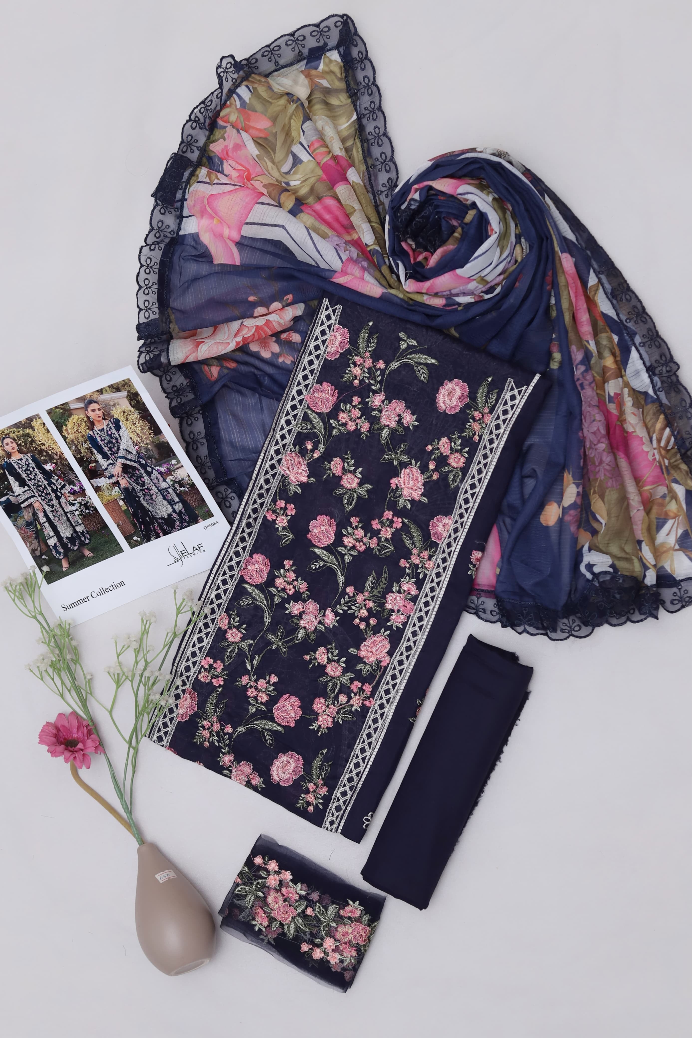 Shop the Maria B Jade luxury lawn 3-piece suit with heavy multi-head embroidery and a ready-to-wear digital print Swiss voile dupatta. Order now from IZ Pattern and Place.