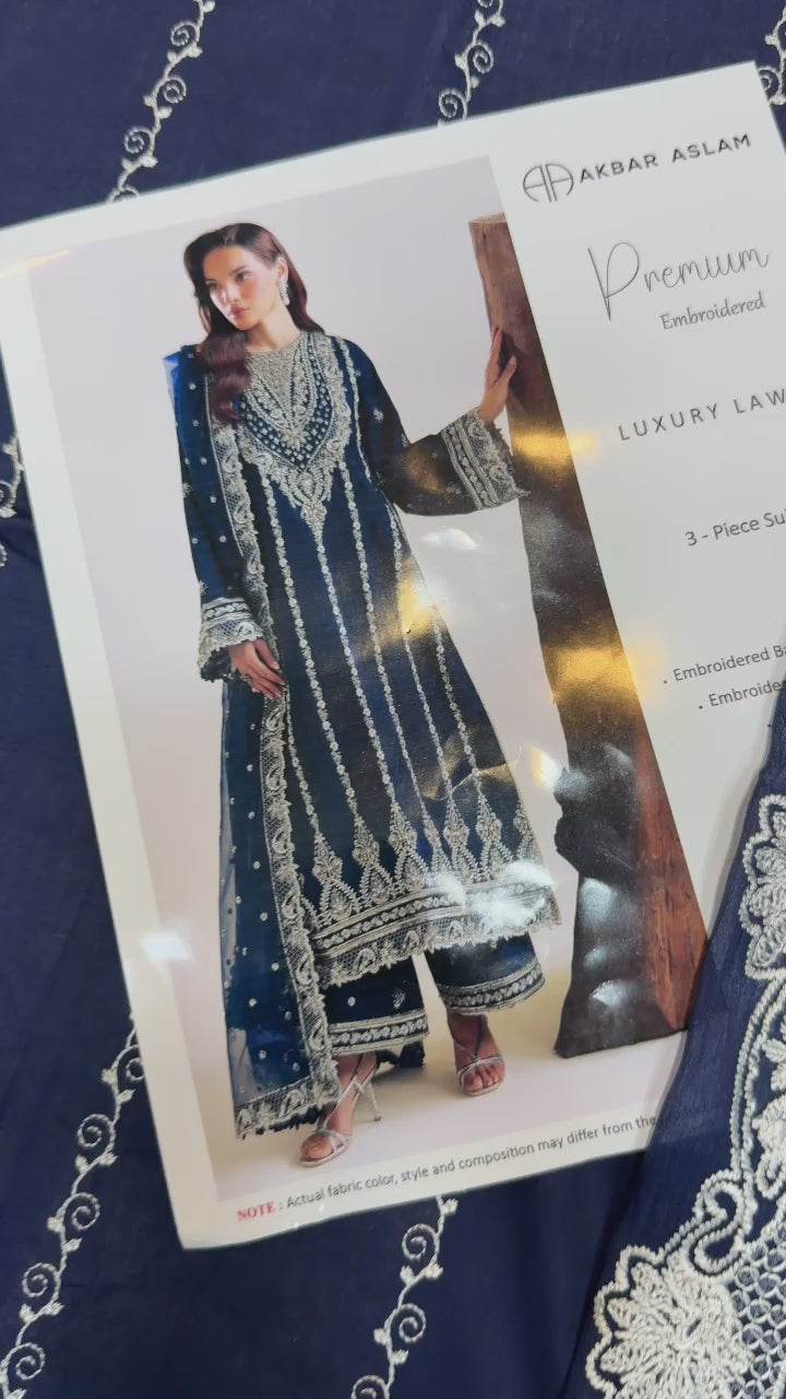 Shop the Akbar Aslam luxury lawn 3-piece unstitched suit with embroidered front, sleeves, border, and embroidered chiffon dupatta. Order now from IZ Pattern and Place.